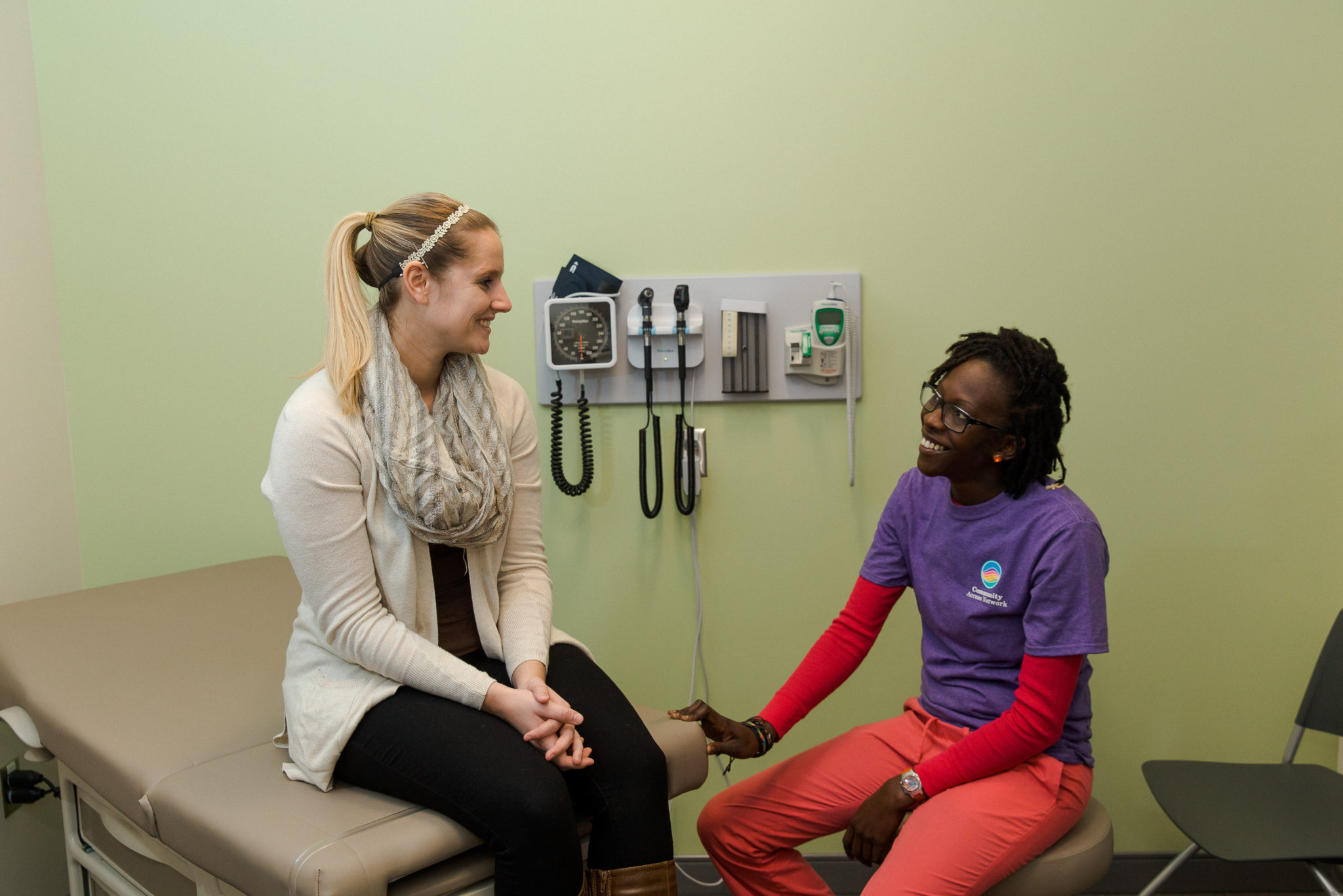 a female doctor speaking with a female patient