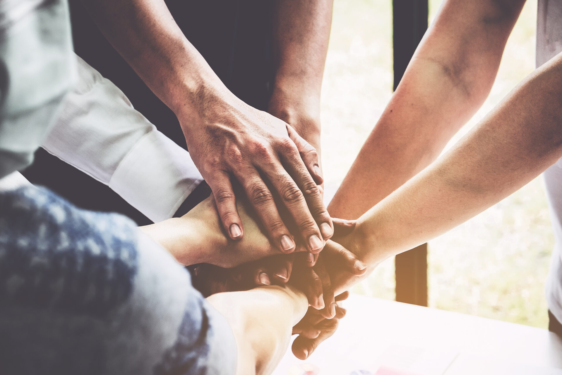 Group of people putting their hands together