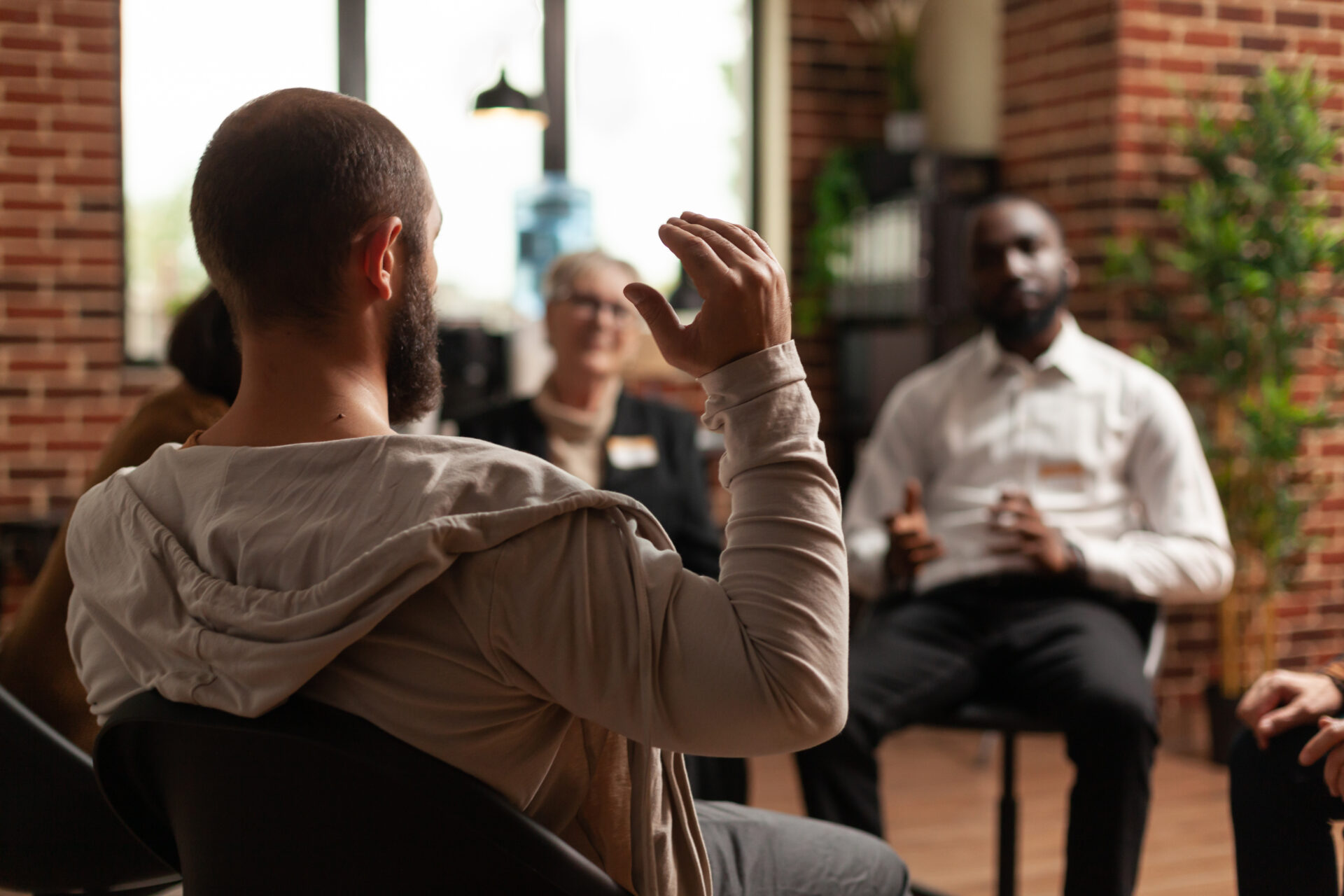 People having conversation about depression and rehabilitation at therapy session.
